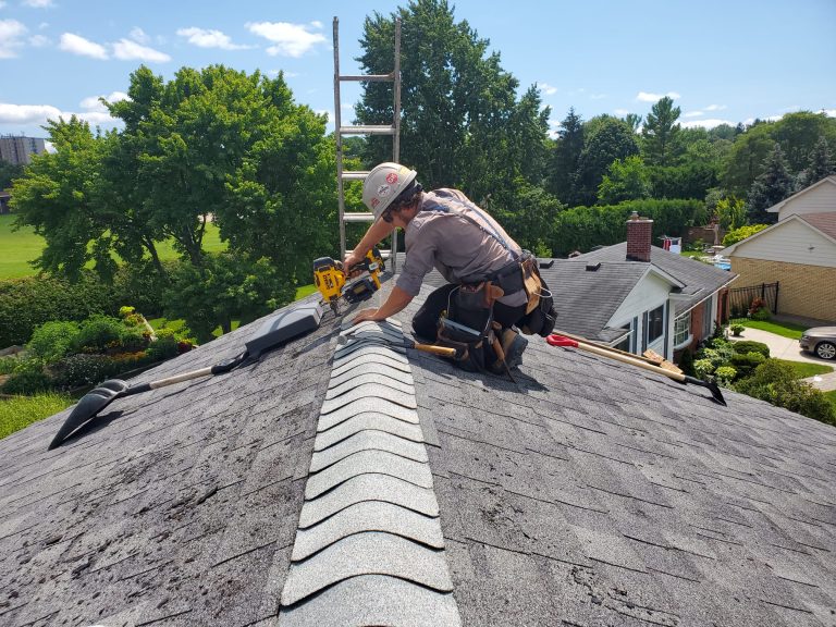 Close-up of plant-based Reactiv8 liquid being sprayed onto asphalt shingles.